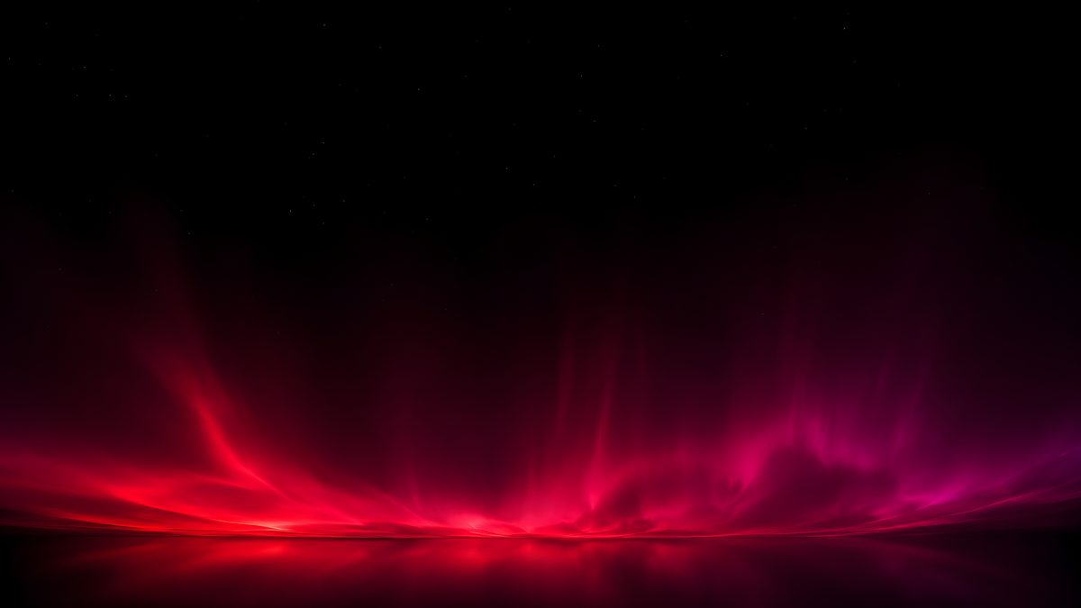 Aurora wallpaper -- red and magenta light low under a black starry sky, free 5K OLED download